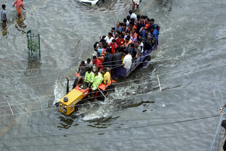 People are rescued in a tractor from a flooded area following heavy rainfall in Patna. (Image: AP)